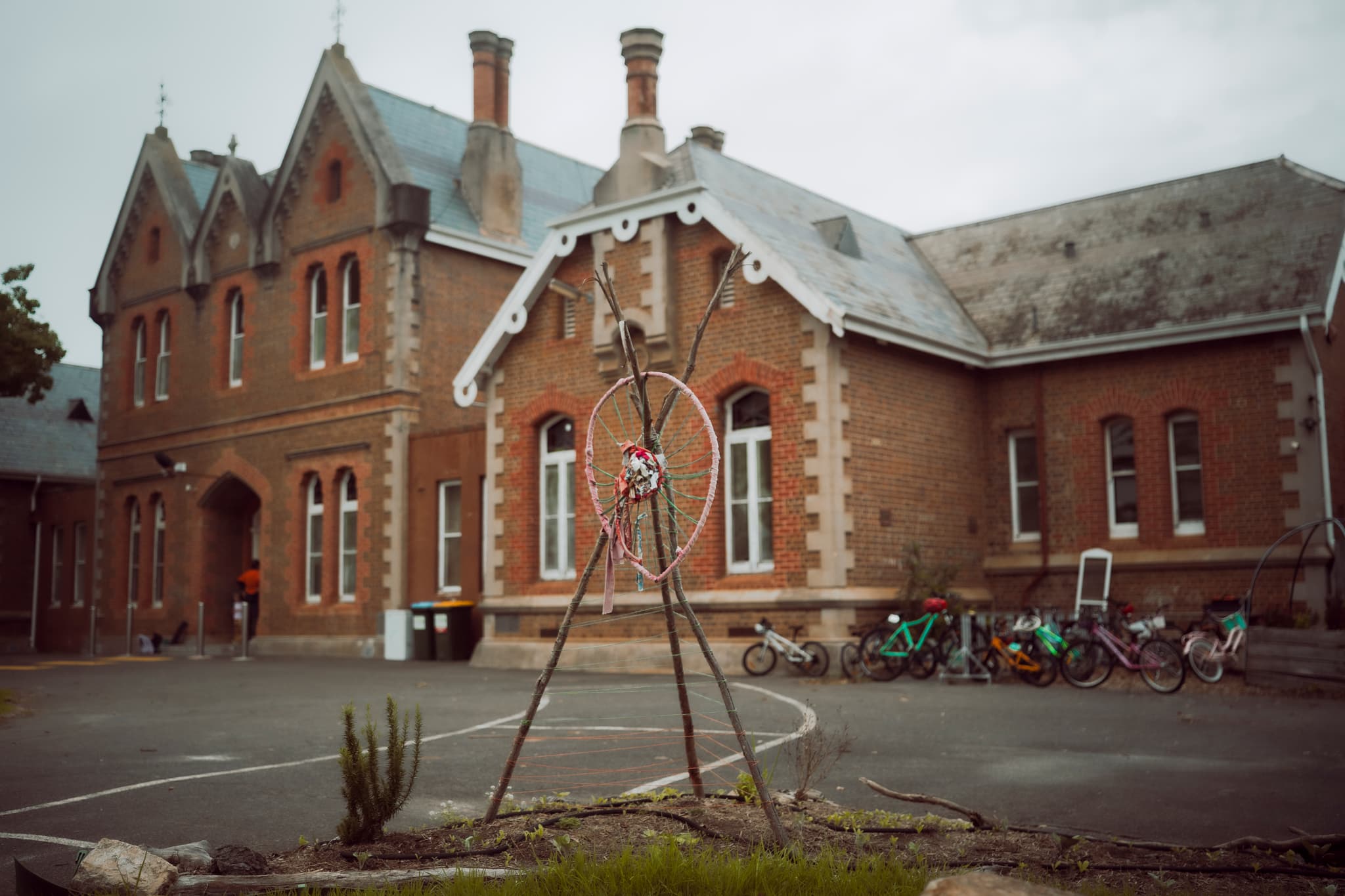 Gothic-revival doorway with dreamcatcher and children's bicycles