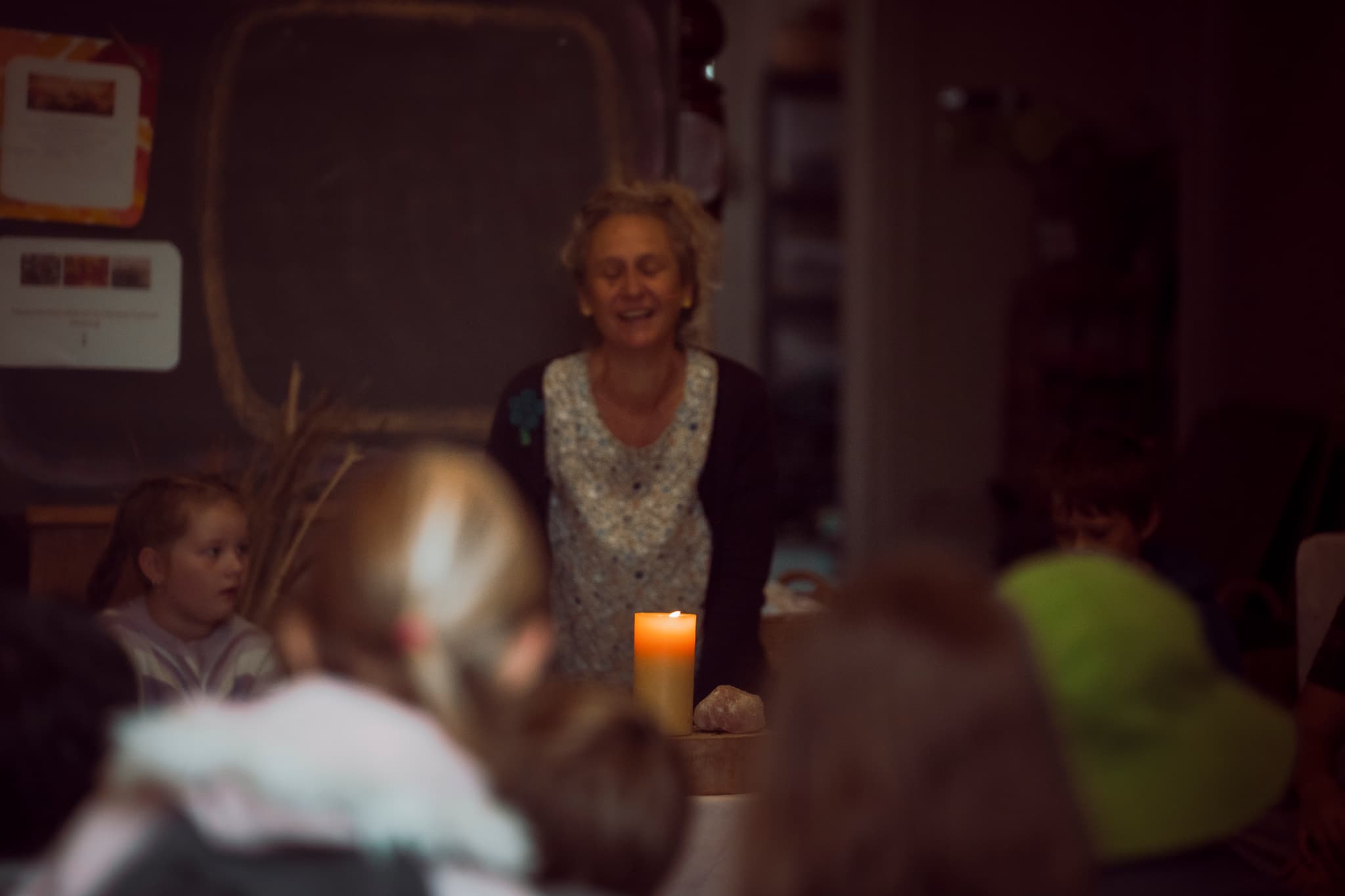 Candlelit storytelling session with gathered children