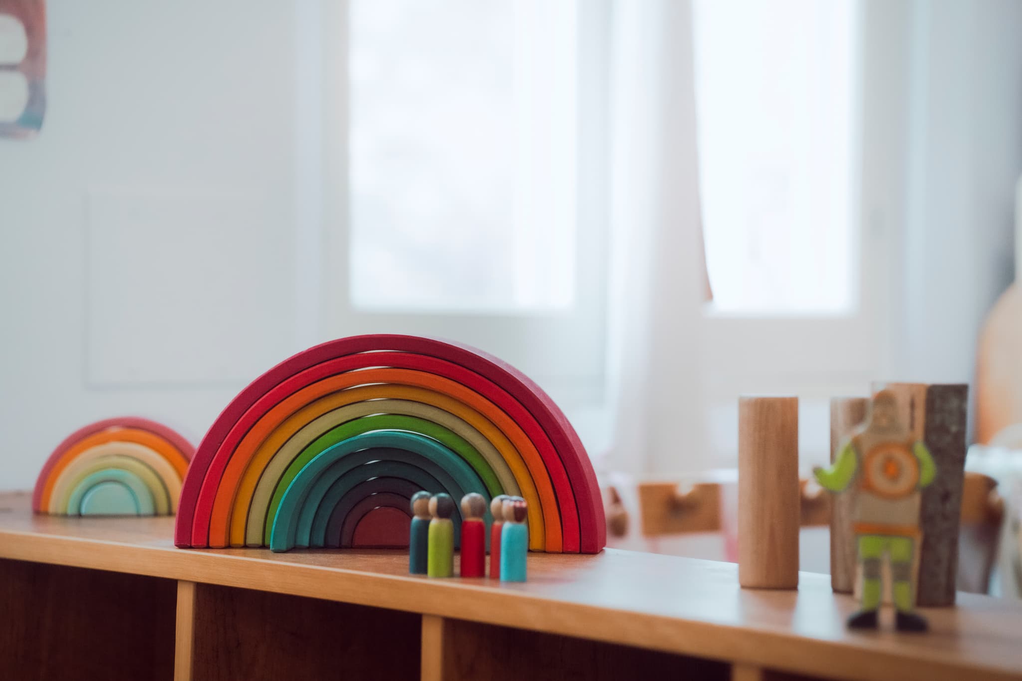 Grimm's rainbow stacker with wooden peg dolls