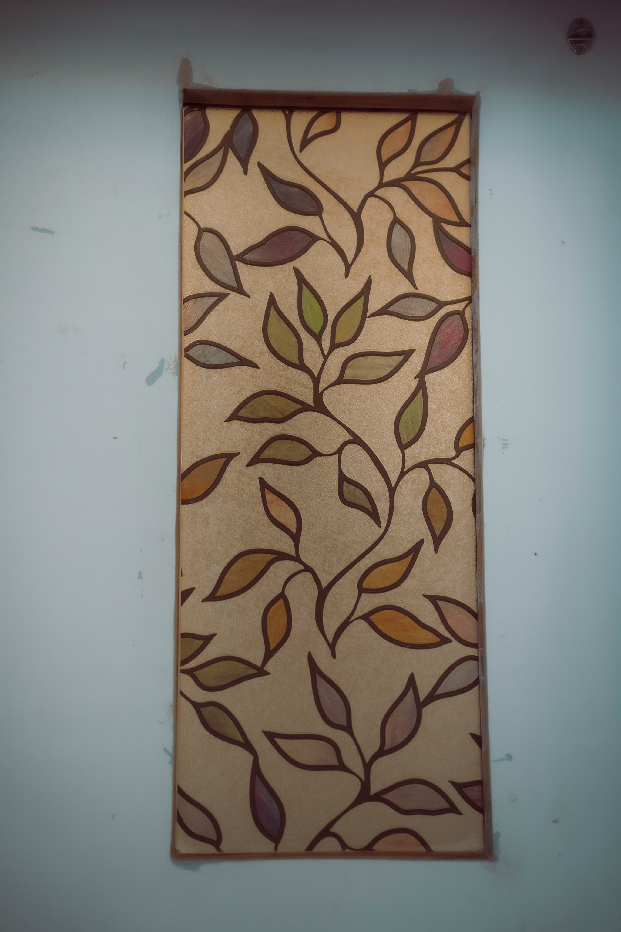 Handmade stained-glass artwork with autumn leaves